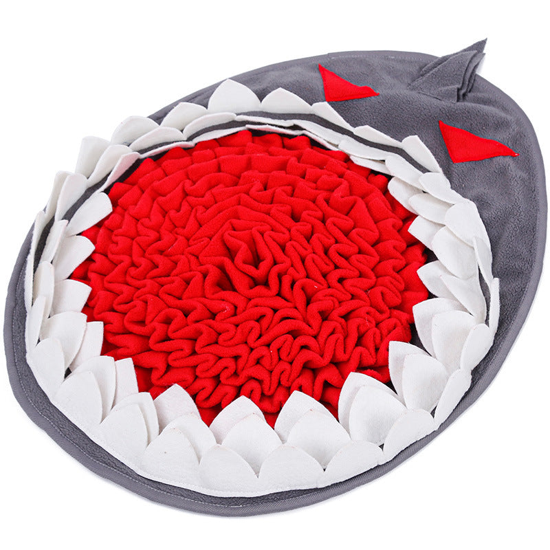 SniffNest snuffle mat in the Shark shape — grey body with white teeth border and red fleece interior, three-quarter view